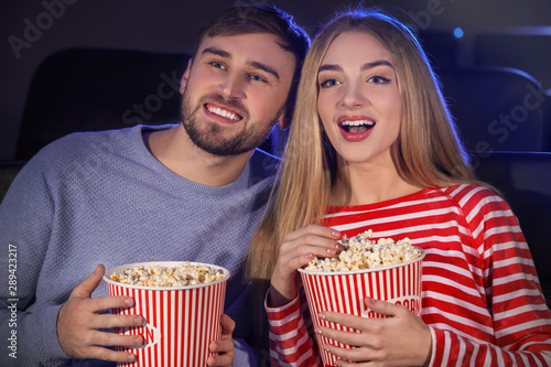 Young couple watching movie...