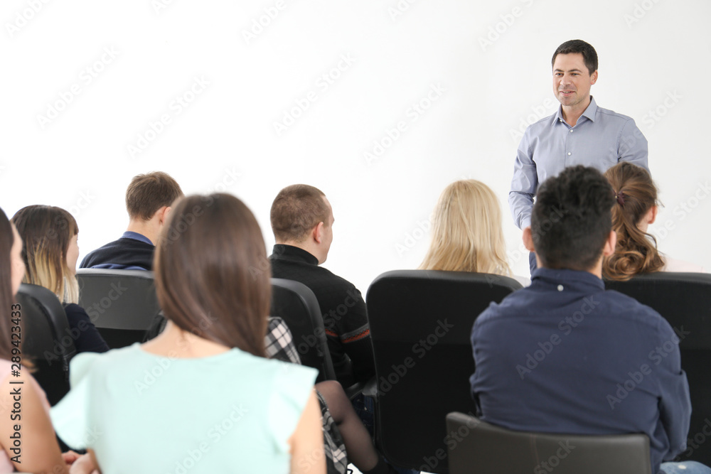 Group of people with business trainer at management seminar