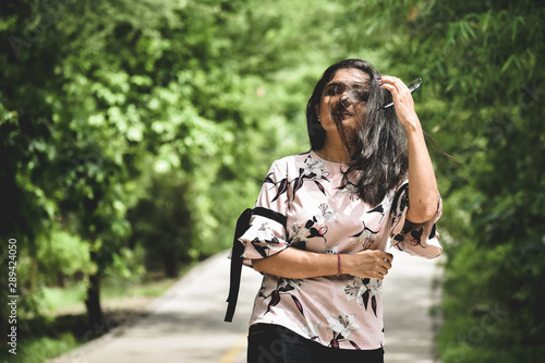 Indian girl standing in park and flowing her hair over face , at Rajkot, Gujarat, India. photo