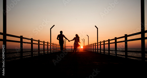 Lovers silhouette on bridge sunset time © kirakos