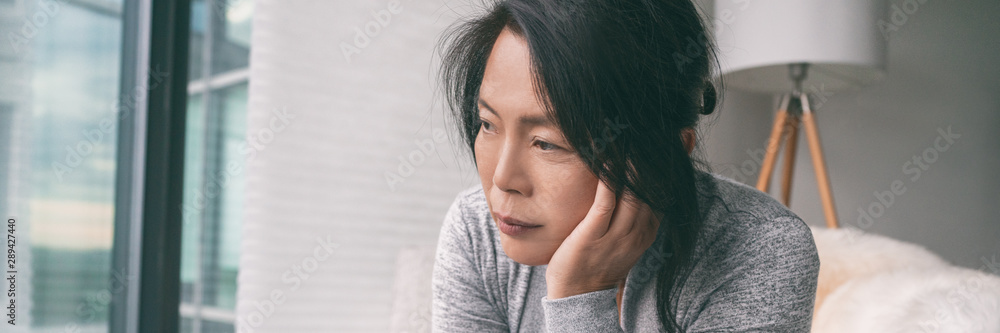 Sad depressed Asian woman having anxiety or depression during autumn season with seasonal affective disorder panoramic banner. - obrazy, fototapety, plakaty 