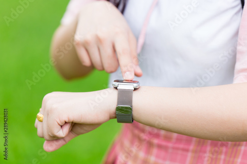 Smart watch closeup girl teen wist hand using watch touch screen