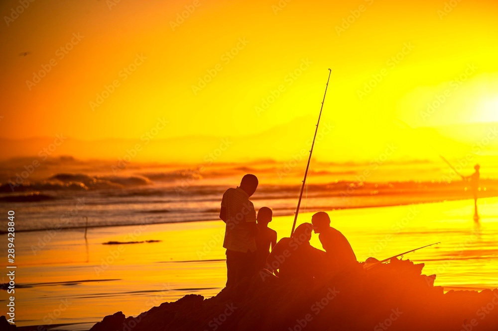 Fisherman at sunset on Maitland Beach, South Africa