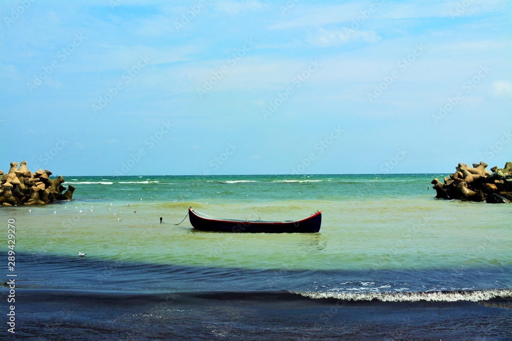 Fototapeta premium an old wooden boat by the sea shore