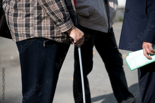 disabled or elderly person with a stick