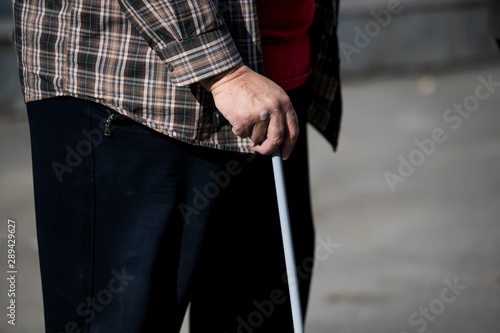 disabled or elderly person with a stick