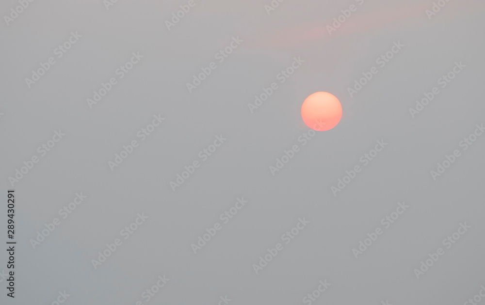 Sunrise sky covered with haze , making it look unusual