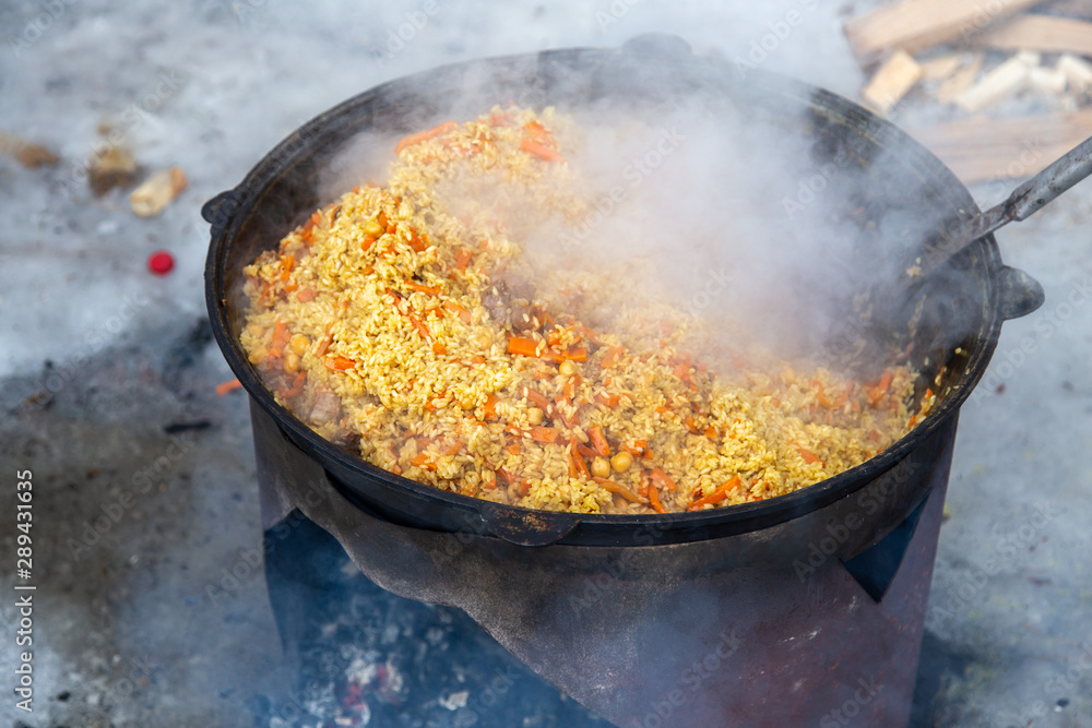Pilaf in a cauldron is prepared in the winter Pilaf in a cauldron is prepared in the winter