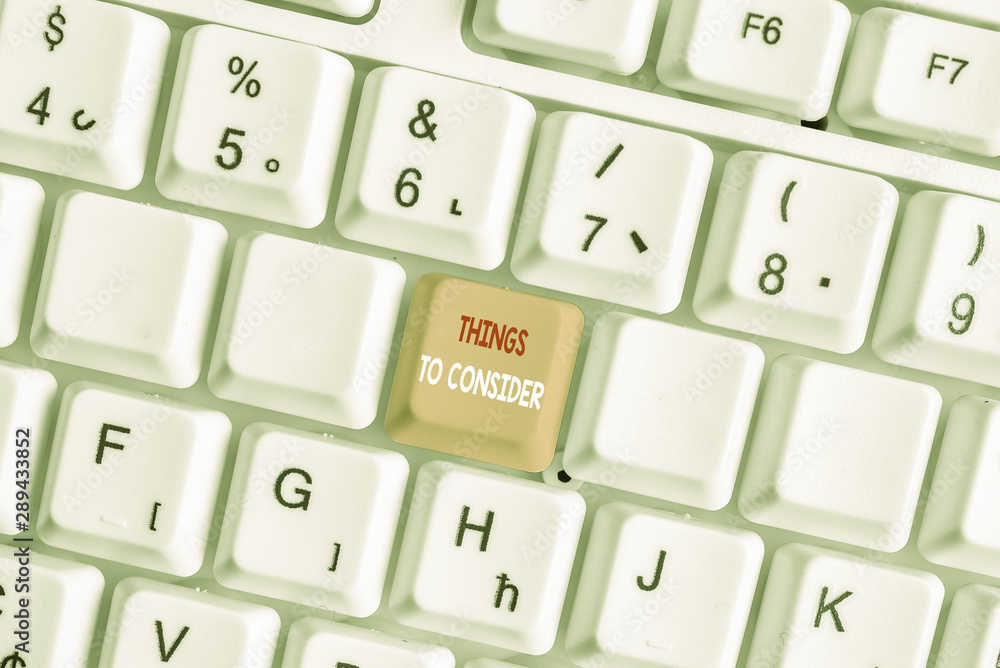 Writing note showing Things To Consider. Business concept for think about carefully especially in making decisions White pc keyboard with note paper above the white background Writing note showing Things To Consider. Business concept for think about carefully especially in making decisions White pc keyboard with note paper above the white background