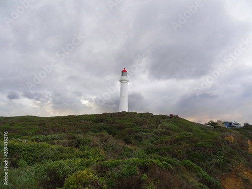 Lighthouse in the coast of Australia. Beautiful clouds in the sky.
