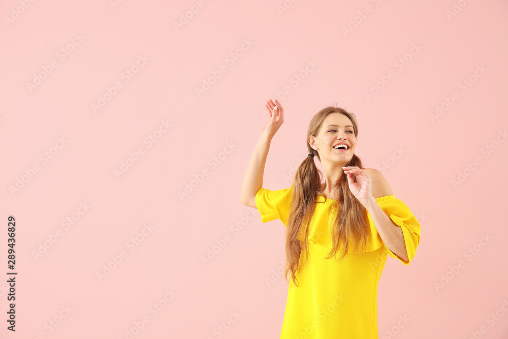 Beautiful young woman dancing against color background Beautiful young woman dancing against color background