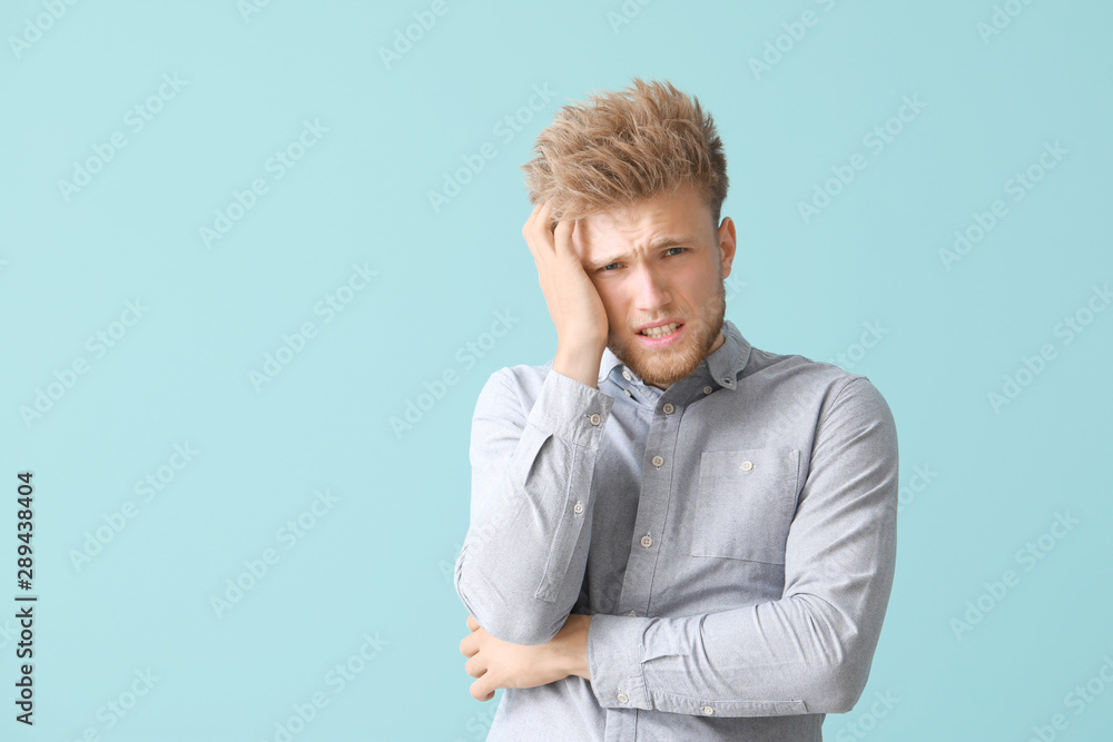 Stressed young man on color background Stressed young man on color background