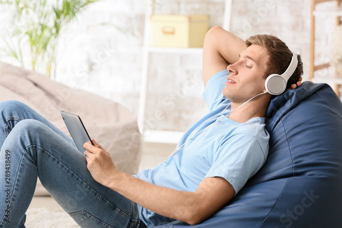 Young man relaxing and list...