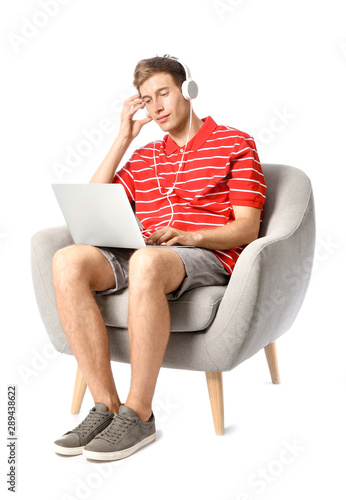 Young man with laptop liste...