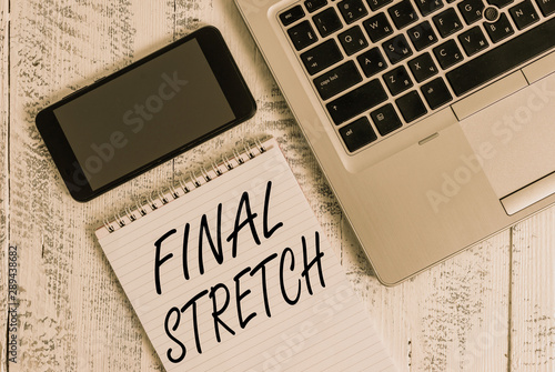 Handwriting text Final Stretch. Conceptual photo Last Leg Concluding Round Ultimate Stage Finale Year ender Metallic laptop blank ruled notepad smartphone lying old wooden table