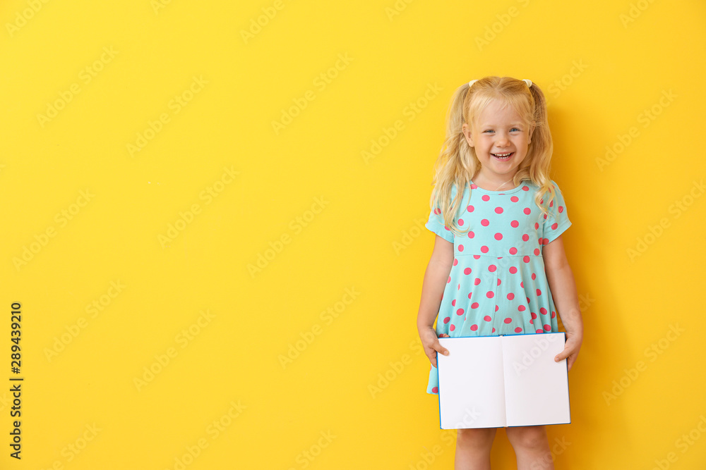 Cute little girl with book on color background - obrazy, fototapety, plakaty 