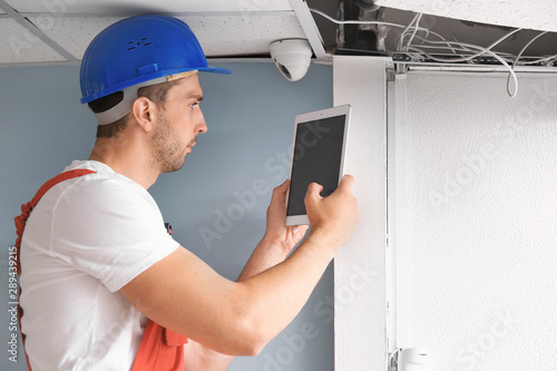 Electrician with tablet com...