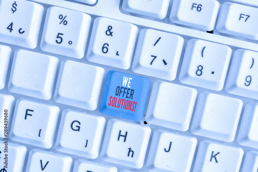 Writing note showing We Offer Solutions. Business concept for way to solve problem or deal with difficult situation White pc keyboard with note paper above the white background Writing note showing We Offer Solutions. Business concept for way to solve problem or deal with difficult situation White pc keyboard with note paper above the white background