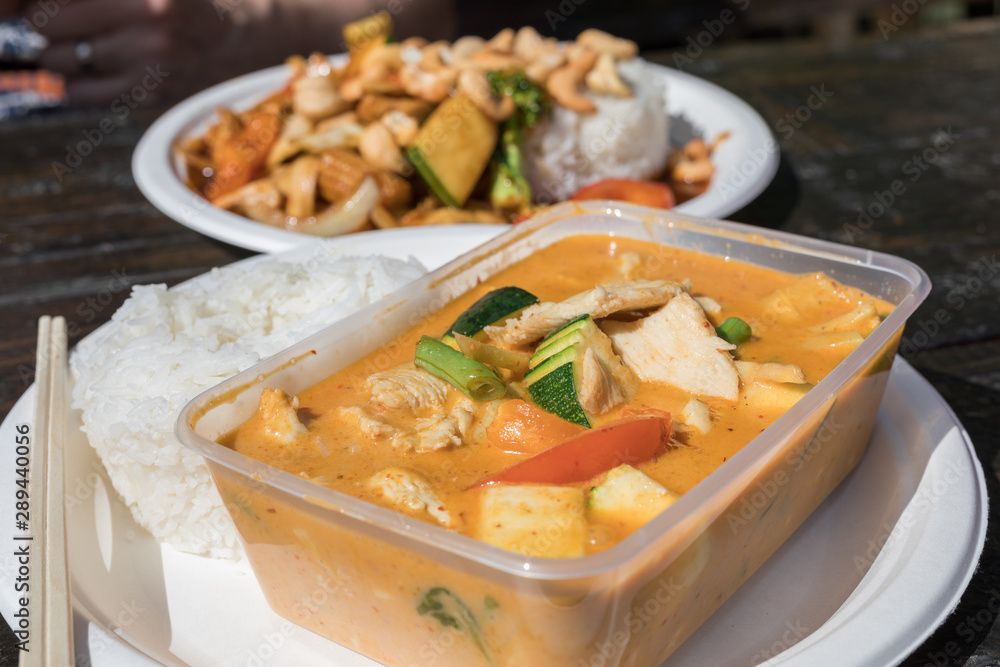 Thai food take away in plastic container and on a paper plate. Thai food take away in plastic container and on a paper plate.