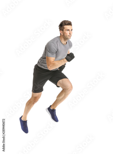 Running sporty man with wrist bands on white background