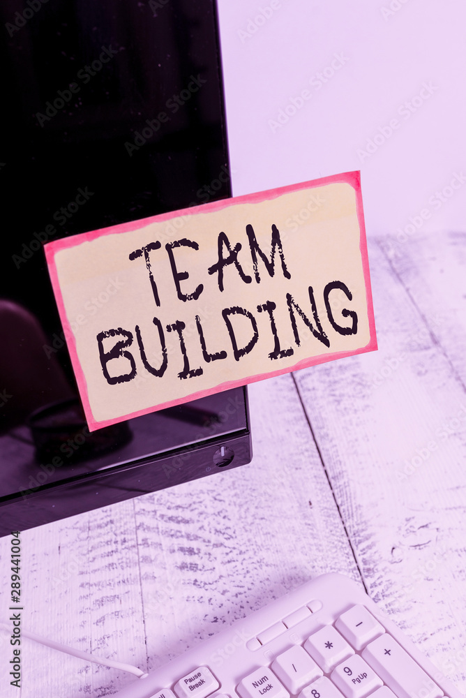 Word writing text Team Building. Business photo showcasing various types of activities used to enhance social relations Notation paper taped to black computer monitor screen near white keyboard Word writing text Team Building. Business photo showcasing various types of activities used to enhance social relations Notation paper taped to black computer monitor screen near white keyboard