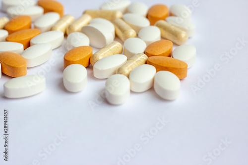 Many different pharmaceutical medicine pills, tablets and capsules on white background. Pharmacy theme, health care, drug prescription for treatment medication and medicament