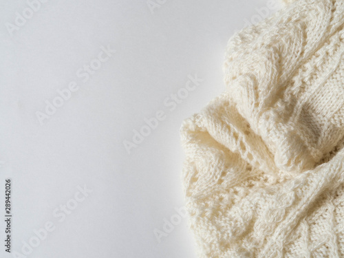 Warm knitted light plaid on a white background Copy space