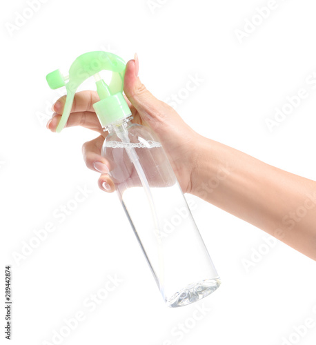 Female hand with bottle of air freshener on white background