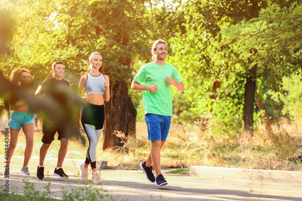 Group of sporty young people running outdoors Group of sporty young people running outdoors