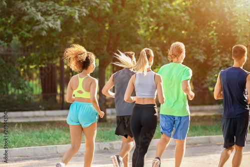 Group of sporty young people running outdoors