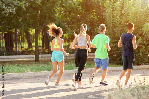 Group of sporty young people running outdoors