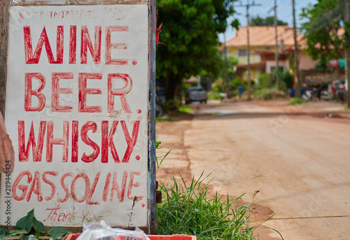 roadside sign, where it puts, wine, beer, whiskey, and gasoline photo