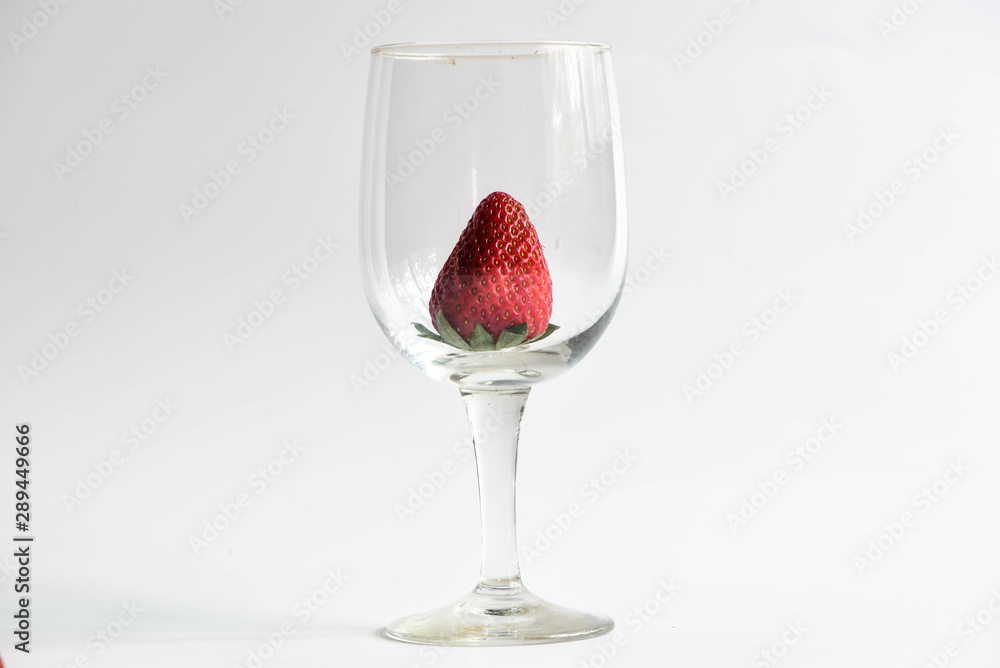 Strawberry in wine glass on white background Strawberry in wine glass on white background