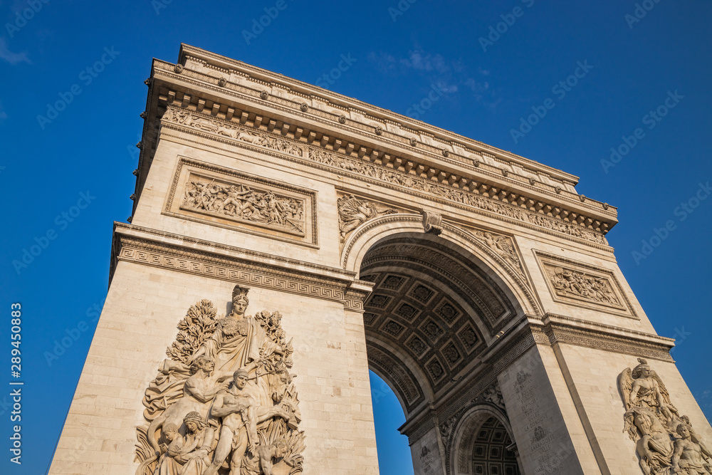 Obraz premium Low angle shot the Arc de Triomphe, Paris France, at the center of Place Charles de Gaulle, formerly named Place de l'Etoile