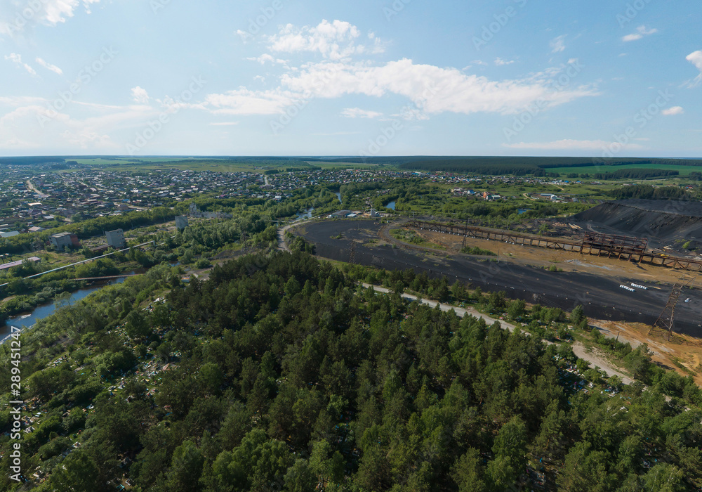 Forest cemetery and industrial area in Rezh city. Sverdlovsk region, Russia. Aerial, summer, sunny Forest cemetery and industrial area in Rezh city. Sverdlovsk region, Russia. Aerial, summer, sunny