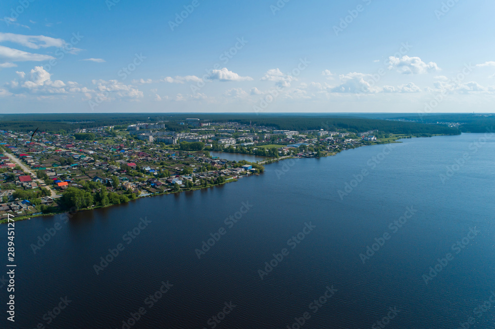 Rezh city and pond. Russia, Sverdlovsk region. Summer, sunny. Aerial