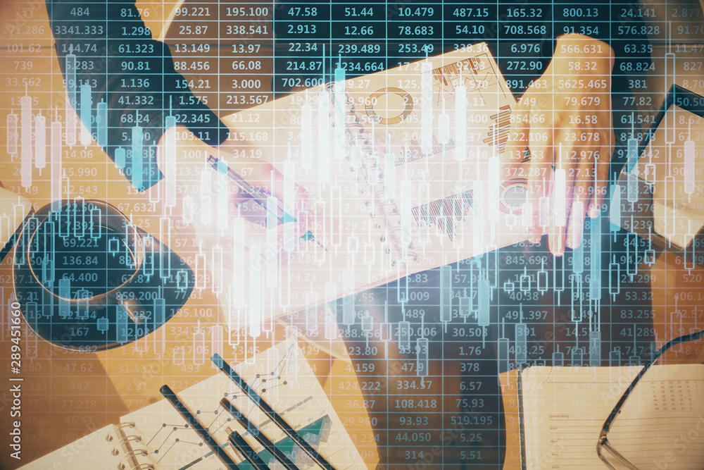 Double exposure of hands making notes with forex chart huds. Stock market concept. Double exposure of hands making notes with forex chart huds. Stock market concept.