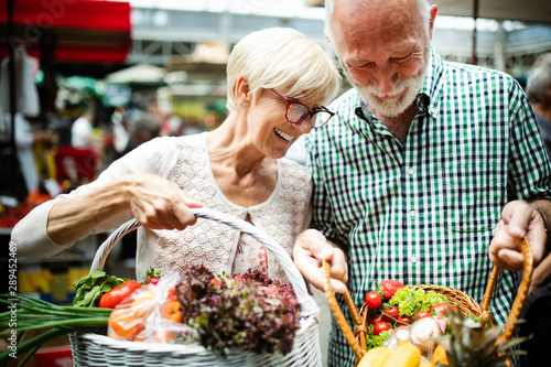 Konstfotografi Mature couple shopping vegetables and fruits on the market