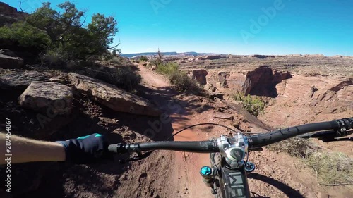 Riding A Narrow Trail On A Mountain Bike