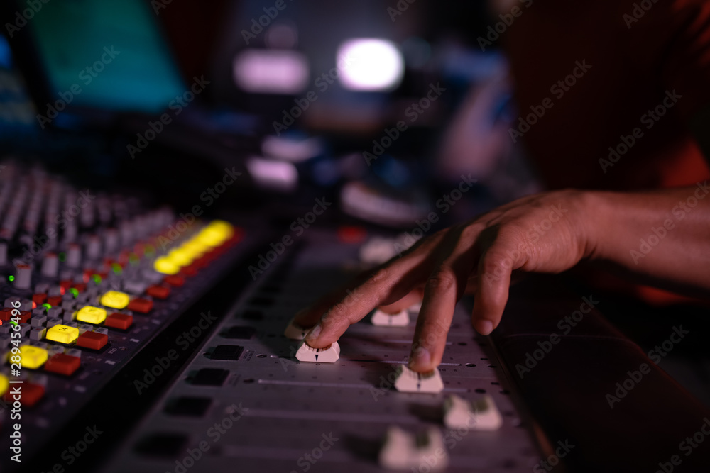 Male music producer working at the mixing desk in a sound studio Male music producer working at the mixing desk in a sound studio