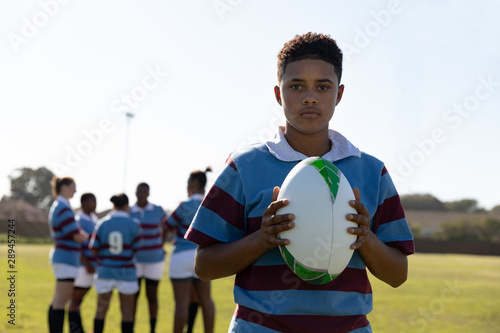 Portrait of young adult female rugby player on a rugby pitch