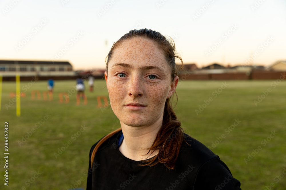 Portrait of young adult female rugby player on a rugby pitch Portrait of young adult female rugby player on a rugby pitch