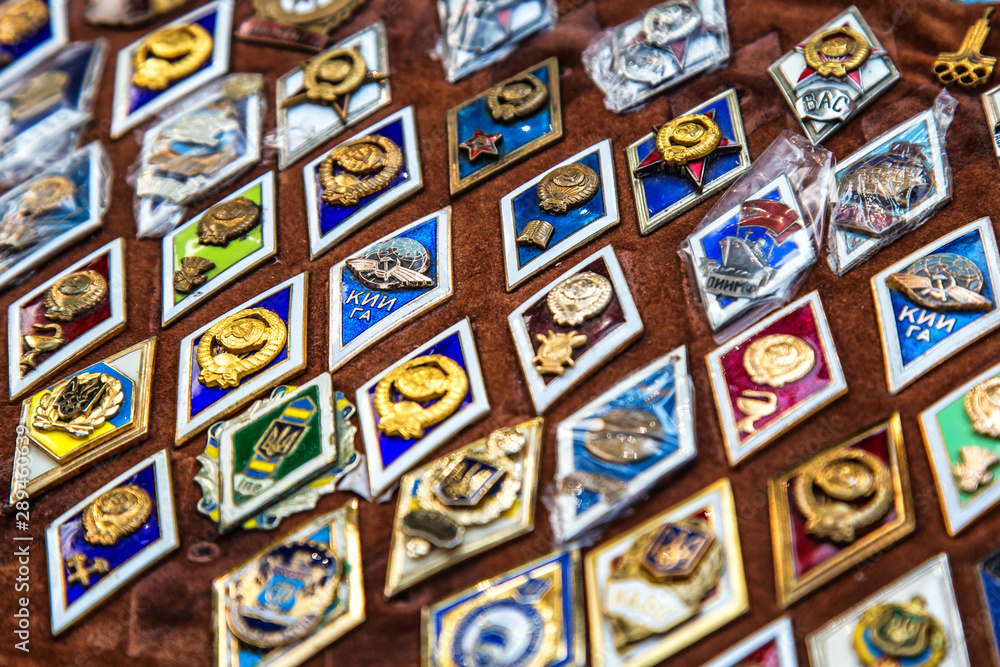 Kiev, Ukraine, August 23. 2019.Close View Of Soiet Russian Medals In Shop Flea Market Of Antiques A large collection of old icons is sold on the market. Different Soviet emblems on the red canvas
