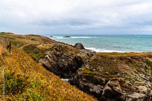 Scenic view of cliffs and sea against sky