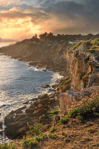 Lighthouse by the sea in Cascais in Portugal at dramatic sunset