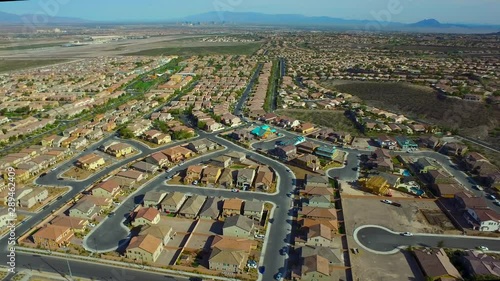 Sliding Aerial shot High above new homes being built in the desert of Nevada near Las Vegas. Smooth Flying overlooking light traffic