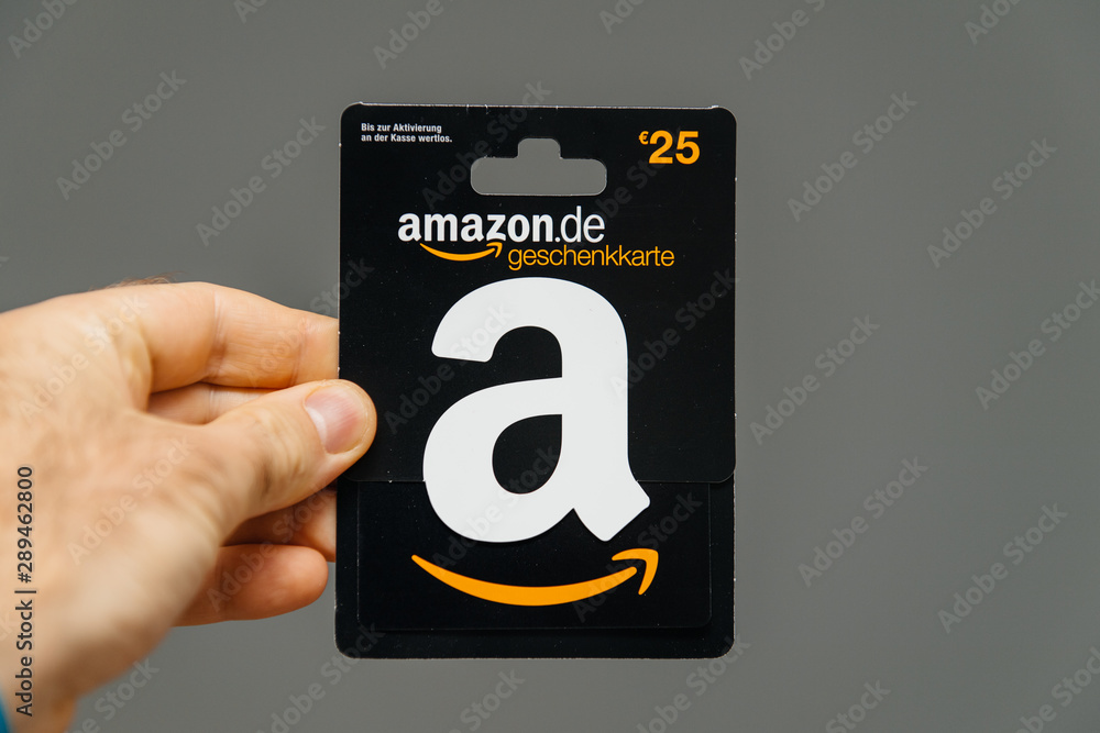 PARIS, FRANCE - APR 1, 2018: Man holding against gray background 25 Euros  Amazon gift card issued by Amazon Germany, valid in Austria as well  Stock-Foto | Adobe Stock
