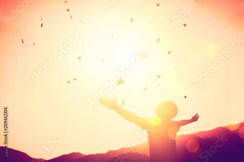 Copy space of man raise hand up on top of mountain and sunset sky abstract background. photo