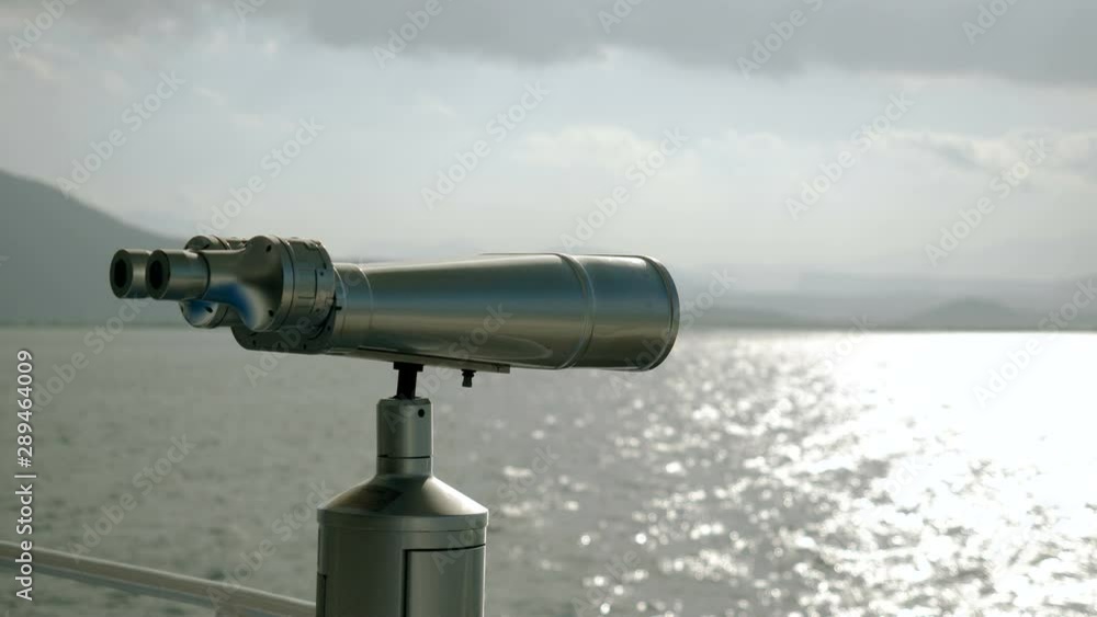 Close-up shot of tourist binoculars on deck of cruise ship against Mediterranean sea. Greece. 4K Close-up shot of tourist binoculars on deck of cruise ship against Mediterranean sea. Greece. 4K
