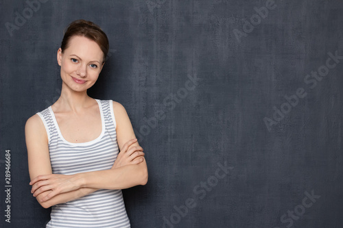 Portrait of happy woman crossing arms over body